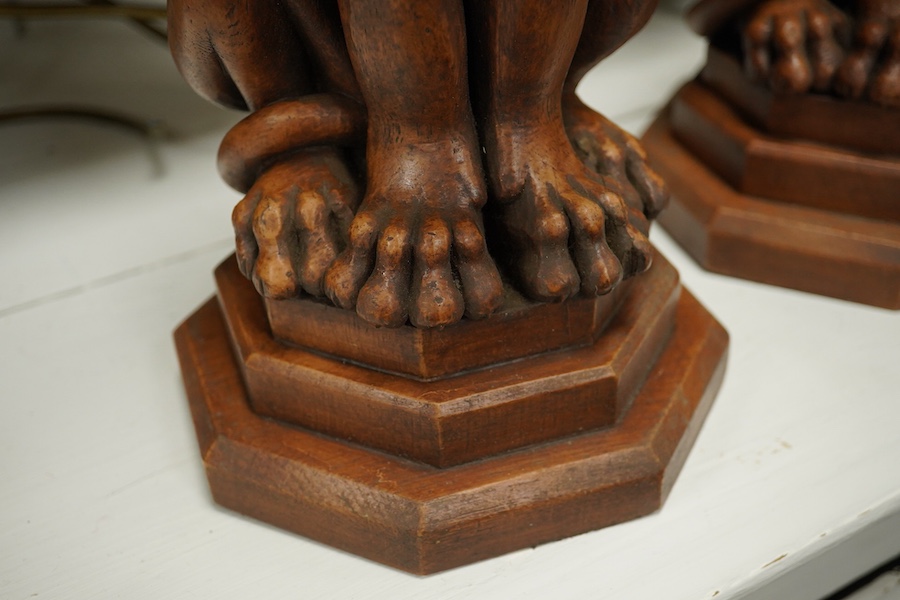 A pair of Thomas Blakemore faux oak 'lion' lamp bases, 47cm high overall. Condition - some minor chips
